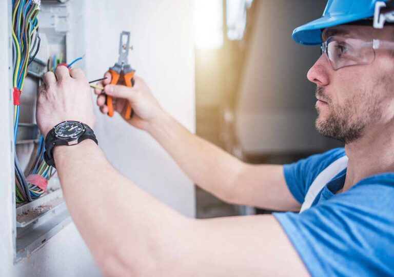 electrician-adjusting-electrical-panel-in-home